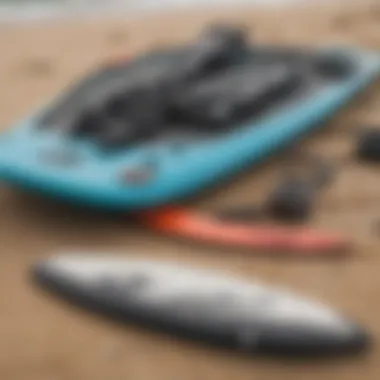 Close-up of essential kiteboarding gear laid out on a sandy beach, illustrating the necessary equipment for enthusiasts