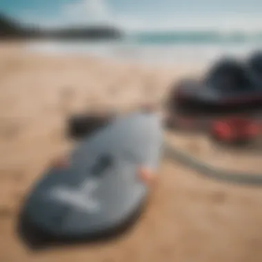 Close-up of essential kitesurfing gear laid out on the sand