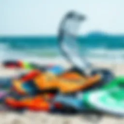 A detailed view of various kiteboarding kites laid out on the beach