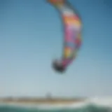 A vibrant kiteboarding scene showcasing colorful kites against the blue sky