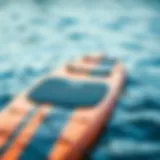 A Naish SUP board showcasing its sleek design and vibrant colors on the water.