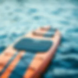 A Naish SUP board showcasing its sleek design and vibrant colors on the water.