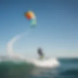 A vibrant North Kitesurf kite soaring high against a clear blue sky