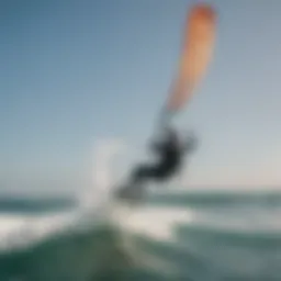 A kiteboarder gliding over ocean waves