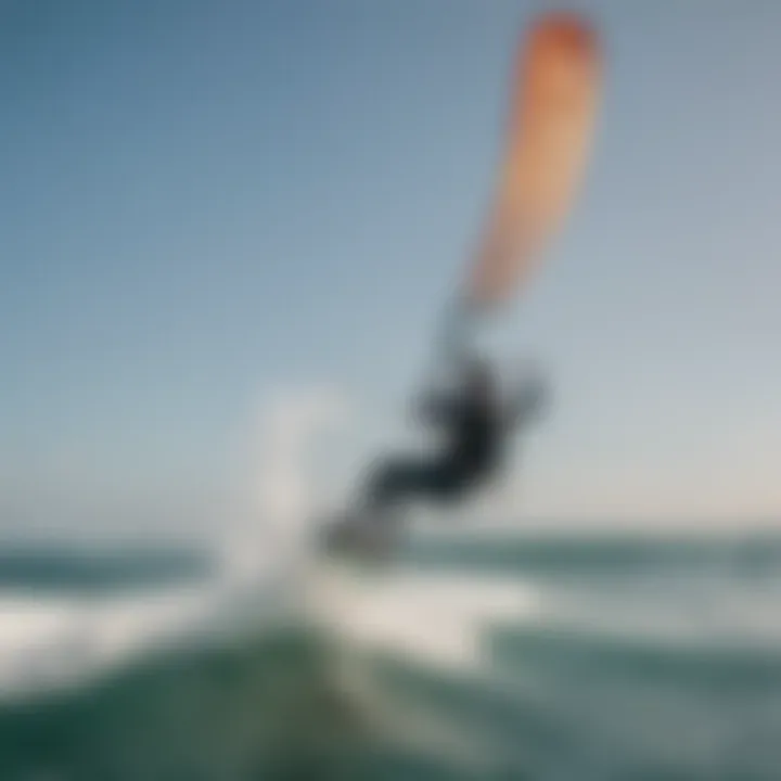 A kiteboarder gliding over ocean waves