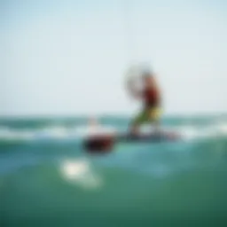 Kiteboarder riding the waves under a clear sky