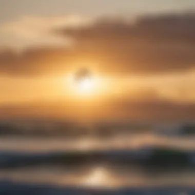 A picturesque sunset over the ocean with kiteboarders in the distance