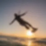 A kiteboarder soaring above the waves with a sunset backdrop