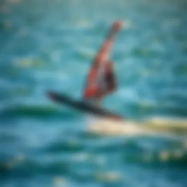 Windsurfer demonstrating hydrofoiling technique on the water