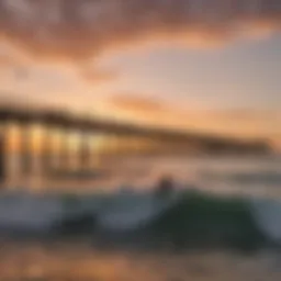 A breathtaking view of Venice Beach Pier at sunset with kiteboarders in action