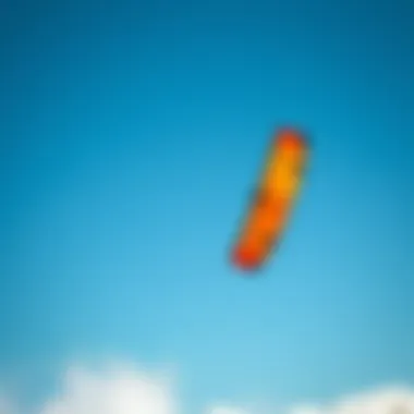 Vibrant kite soaring across the clear blue sky during a kiteboarding session