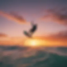 A kiteboarder soaring through the air against a vibrant sunset.