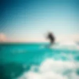 A breathtaking view of a kiteboarder gliding over crystal-clear waters