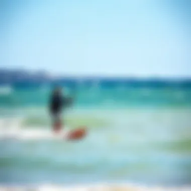 A beginner kite surfer practicing on calm waters with a coach guiding them