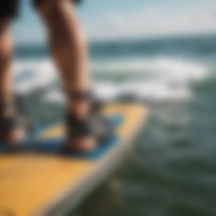 Kiteboarder adjusting foot straps for a secure fit on the board