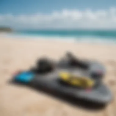 Kiteboarding gear laid out on a sandy beach