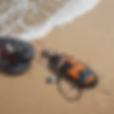 Close-up of kitesurfing equipment laid out on the sand