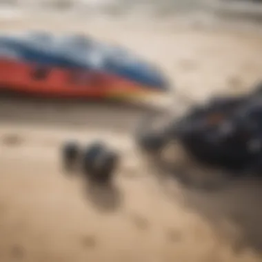 Close-up of essential kite surfing gear laid out on the sand.