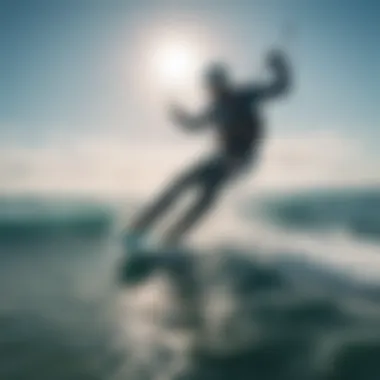 A kitesurfer gliding across vibrant blue waves under a clear sky