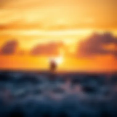 A kiteboarder gliding across the waves in a vibrant sunset