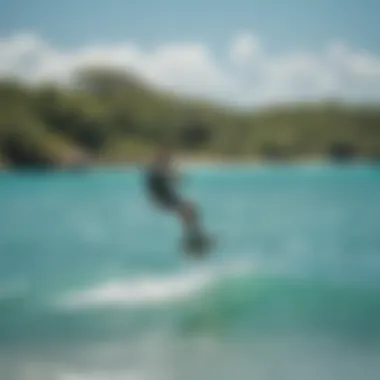 A kiteboarder gliding over the vibrant turquoise waters