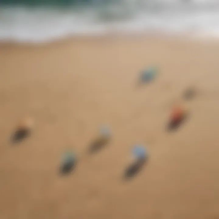 An array of different kite sizes laid out on the beach for comparison.