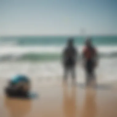 A group of kiteboarders discussing helmet options on the beach.