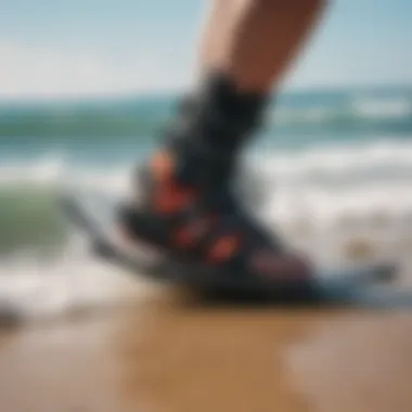 Kitesurfer adjusting foot straps for optimal performance.