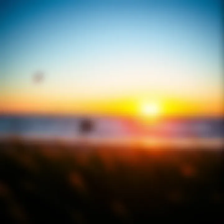 A vibrant sunset over West Dennis Beach with kiteboarders in the distance