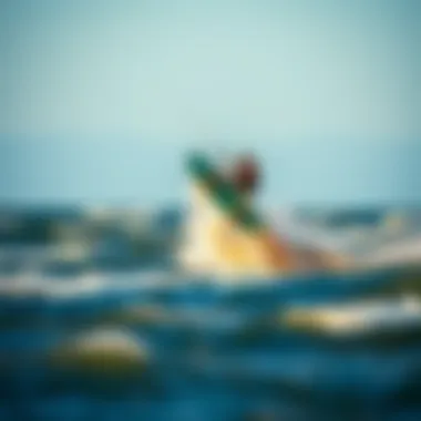 Kiteboarder performing an aerial trick on the waves of West Dennis Beach