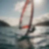 A windsurfer gracefully foiling above the water surface